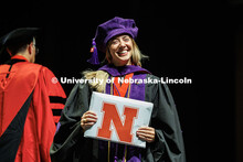 Heather Haratsis smiles at her parents in the crowd after receiving her diploma on stage at the 2025