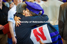 Jori Peters hugs a family member after the graduation ceremony. She earned a Juris Doctor with disti