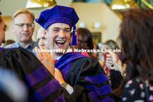 A graduate smiles at family members after the graduation ceremony. 2025 College of Law commencement 