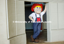 Brady Moylan as Herbie leans against a column in Memorial Stadium. Moylan has been Herbie for the la