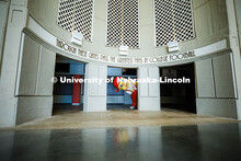 Ben Hastreiter as ‘Lil Red peaks out from behind a column in Memorial Stadium. Hastreiter has been