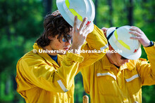 Ben Beiermann, a senior Fisheries and Wildlife major, puts on his hard hat in preparation to dig a f