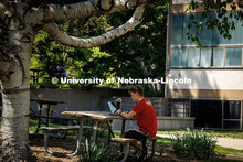 Michael Macabobby, a senior Biochemistry major, studies for finals outside Woods Art Building on Cit