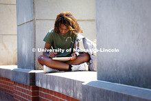 Sophomore Ayana Robbins works on her iPad at the Meier Commons Greenspace during finals week. May 8,