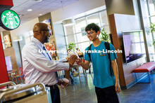 Chancellor Rodney D. Bennett laughs with Zachary Jacobsen (right), a junior Chemistry and Music majo