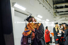 Educational Administration Graduate student, Desteny Miller, hugs her service dog, Maverick, prior t