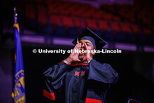 COJMC Graduate student, Jordan Ambrose, yells back to his family members in the crowd at Graduate Co