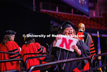 COJMC Graduate student, Kylie Stearns holds up her diploma after receiving it. 2025 Spring Graduate 
