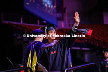 Architecture Graduate student, Jiang Chen, waves to family members after receiving his diploma. 2025
