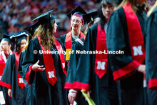 Graduates chat in line during the morning commencement ceremony processional into Pinnacle Bank Aren