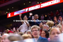Family members cheer and record video of their student in Pinnacle Bank Arena during the processiona