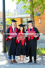 Triplets Josh, Paige and Drew Ferguson pose with their diplomas outside of Pinnacle Bank Arena after