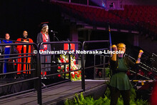 Annie von Kampen sings the final notes of the National Anthem as a translator signs "brave" during t
