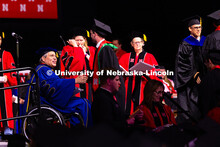 Construction Management graduate Quinny Brumbaugh shakes hands with College of Engineering Dean Lanc