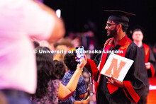 Gowrav Ghatameneni stopped to speak with his family after receiving his diploma. Ghatameneni majored