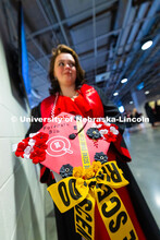Margaret McCabe holds her cap, decorated with crime scene tape and ribbons to represent her degree i