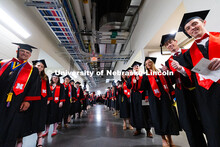 Graduates pose as they line up for the processional into Pinnacle Bank Arena for the University of N
