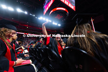 Fisheries and Wildlife graduate Melissa Bussell waves at family members from her seat in Pinnacle Ba