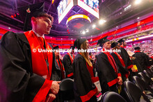Gwyer Leach looks toward the podium in Pinnacle Bank Arena as he waits to receive his diploma. Leach