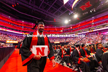 Travis Langemeier grins as he walks back to his seat with his diploma. Langemeier received his Bache