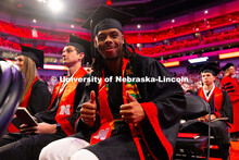 Business Administration graduate Je'Cory Harris gives two thumbs up as he waits to receive his diplo