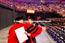 Kenneth Pyle gives a hug to graduate Clara Walstad, who was one of his advisees in the Fisheries and