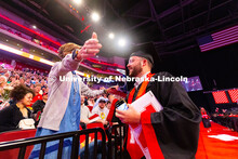 Business Administration graduate Jarrett Michie hugs his mother, Kim Michie, after receiving his dip