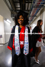 Kalah Williams poses for a photo on her way to join her fellow elementary education graduates for th