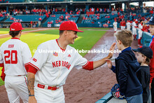 Husker baseball player, Casey Daiss, high-fives young fans. Nebraska vs Minnesota baseball game at H