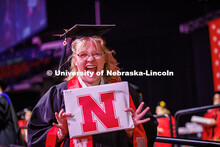Abi Trembly, an Emerging Media Arts major, shows off her diploma after receiving it on stage. May 20