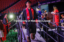 Management major, Brady Moylan, wears Herbie feet for Commencement after spending the last two years