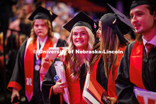 Two grads hug as they walk out of the undergraduate commencement. May 2025 Commencement Undergraduat