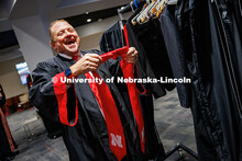 Corrie Svehla, the Assistant Director of Special Events, gets ready for his graduation behind the sc