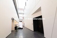 String instruments are placed outside of a line of light wood lockers on the first floor of the new 