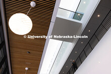 A faculty member walks along the second-floor railing in the new Hixson-Lied College of Fine and Per