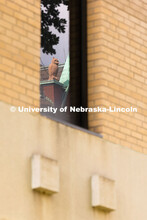 An ornamental owl on top of Architecture Hall is reflected in the windows of the old Westbrook Music