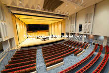 Glenn Korff School of Music students and staff move a harpsichord onto the stage of the newly renova