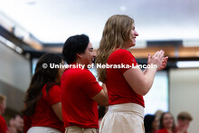 Caroline Belleque claps at the front of the Centennial Room in the Nebraska Union during New Student