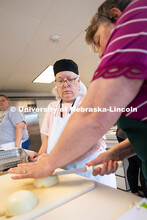Renee Cornett shows Elaine Rouse a method for dicing onions during a Wednesday, cooking class. Both 