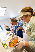 Angela Tauber whisks chopped carrots and jalapenos into a mixture of vinegar and sugar to make quick