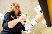 Jen Krueger, Senior Coordinator for Injury Prevention and Care, demonstrates how to wrap a foot afte