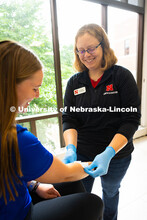 Jen Krueger, Senior Coordinator for Injury Prevention and Care, smiles at Kelci Davis, one of her st