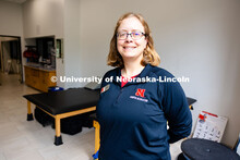 Jen Krueger, Senior Coordinator for Injury Prevention and Care, stands in front of the large windows