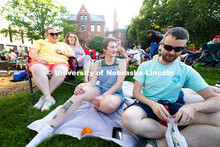 Kristin Mapson (center) sits on a blanket with Joel and Sydney White on Tuesday, June 10 to enjoy Ja