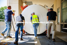 Men from Customized Rigging Inc. and Cassling push the new MRI scanner closer to the room where it w