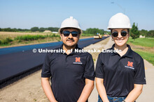 Nitish Bastola and Taisa Medina, PhD Civil Engineering students at UNL, pose for a portrait beside F