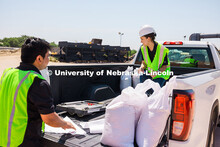 Nitish Bastola and Taisa Medina, PhD Civil Engineering students at UNL, collect aggregate samples to