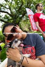 Somdatta Achar, a doctoral student studying agronomy and horticulture, gives a hug to Charlie, who c