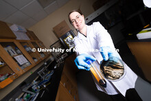 Erin Carr, a postdoctoral research associate in chemical and biomolecular engineering, holds up a pe
