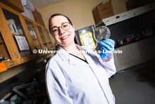 Erin Carr, a postdoctoral research associate in chemical and biomolecular engineering, holds up a pe